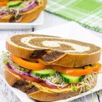 These Sun-Dried Tomato and Garlic Hummus Sandwiches are loaded with delicious, creamy hummus and fresh, crispy veggies. They're the perfect summer lunch!