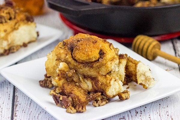 These Cast Iron Skillet Sticky Buns are topped with a tasty honey pecan glaze.  They're a surefire way to cure the winter blues!