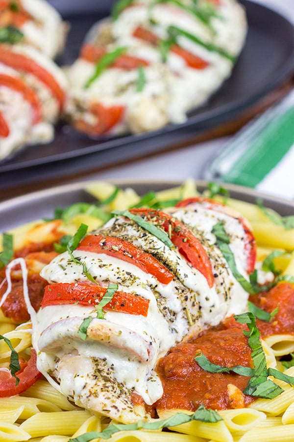 Filled with creamy mozzarella cheese, Roma tomatoes and freshly chopped basil, this Stuffed Chicken Caprese recipe is a new favorite in our house!
