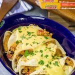 Want to break out of the 'dinner rut'?  Then put these Cheesy Baked Burritos on the menu!  Topped with an easy, homemade cheese sauce, these burritos are the perfect comfort food for chilly days!