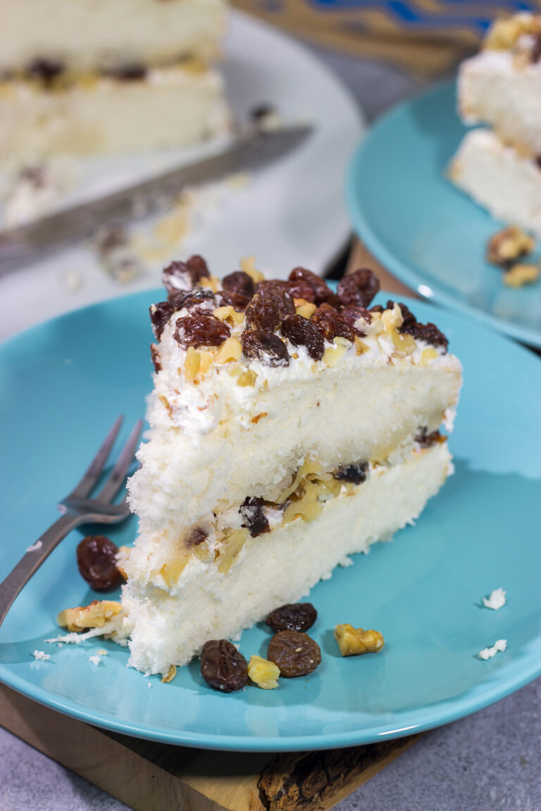 A Lady Baltimore Cake features white cake topped with 2 frostings, toasted walnuts and sherry-soaked raisins. It's truly a unique dessert!