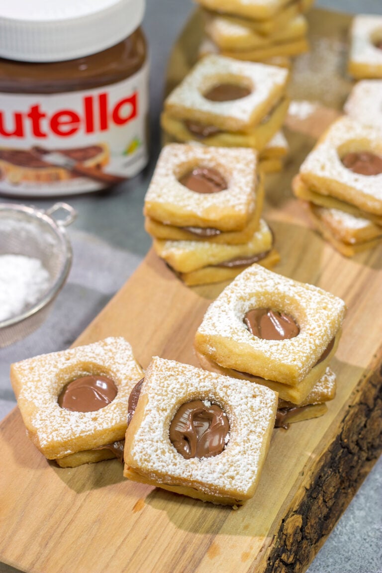 These Nutella Cookies feature buttery shortbread cookies with a schmear of Nutella in between. Good luck eating just one!