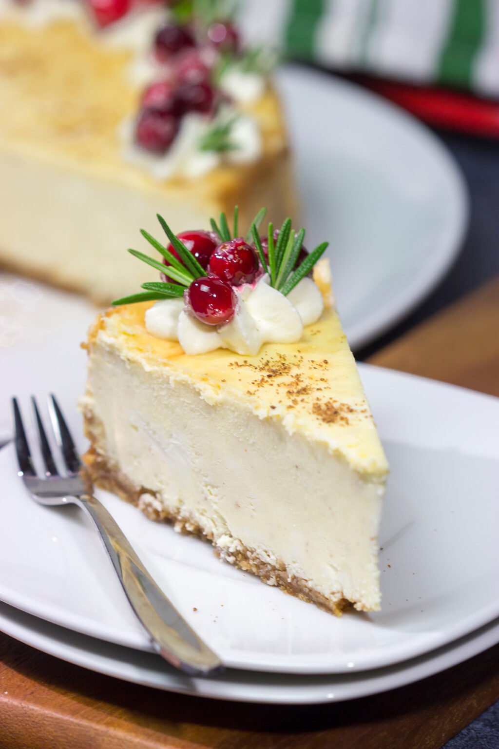 Eggnog Cheesecake Topped with eggnog whipped cream + cranberries!