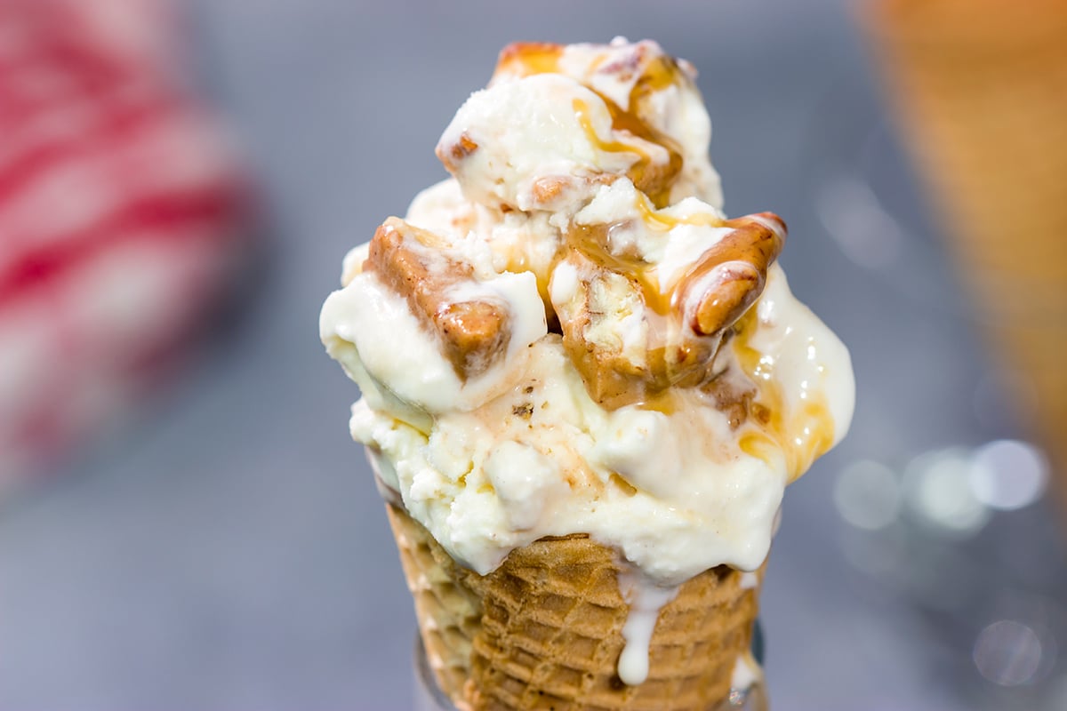 This Caramel Praline Ice Cream features a creamy vanilla base filled with nutty crumbled pralines. It's delicious, and it's perfect for a hot summer day!