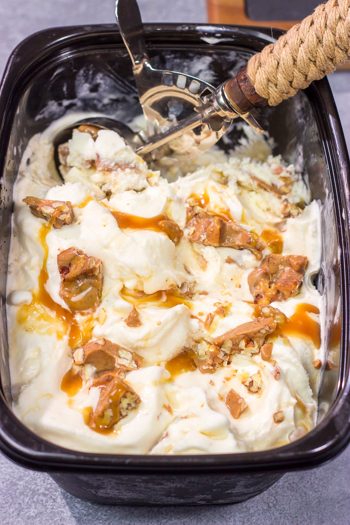 This Caramel Praline Ice Cream features a creamy vanilla base filled with nutty crumbled pralines. It's delicious, and it's perfect for a hot summer day!