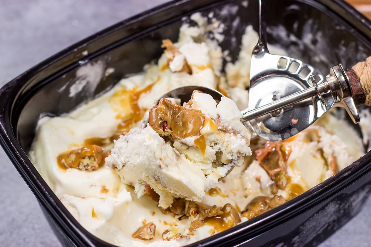 This Caramel Praline Ice Cream features a creamy vanilla base filled with nutty crumbled pralines. It's delicious, and it's perfect for a hot summer day!