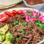 This Slow Cooker Mexican Shredded Beef recipe is tender, juicy and delicious! It's perfect for tacos, burritos or soups and stews. Make a batch tonight, and you'll have meals for the week!