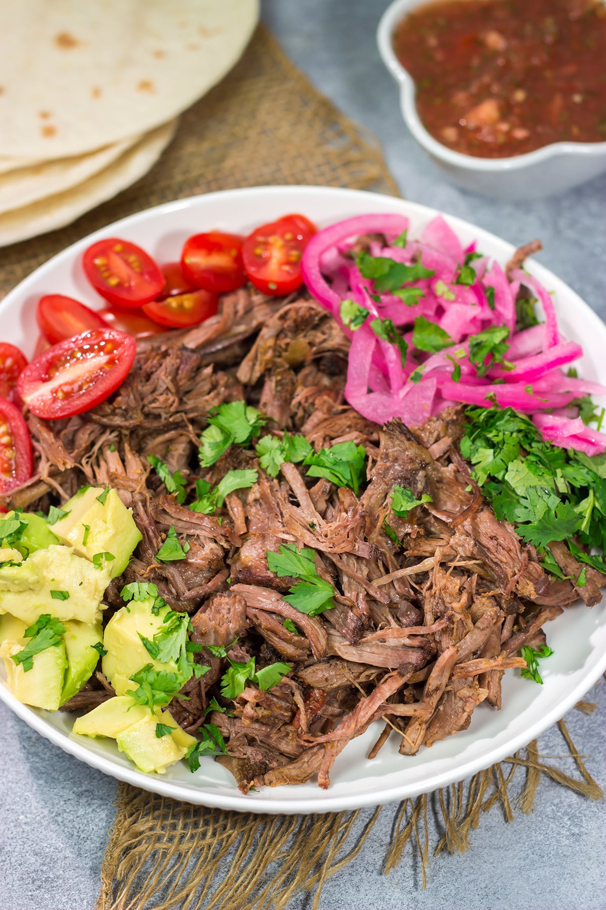 This Slow Cooker Mexican Shredded Beef recipe is tender, juicy and delicious! It's perfect for tacos, burritos or soups and stews. Make a batch tonight, and you'll have meals for the week!