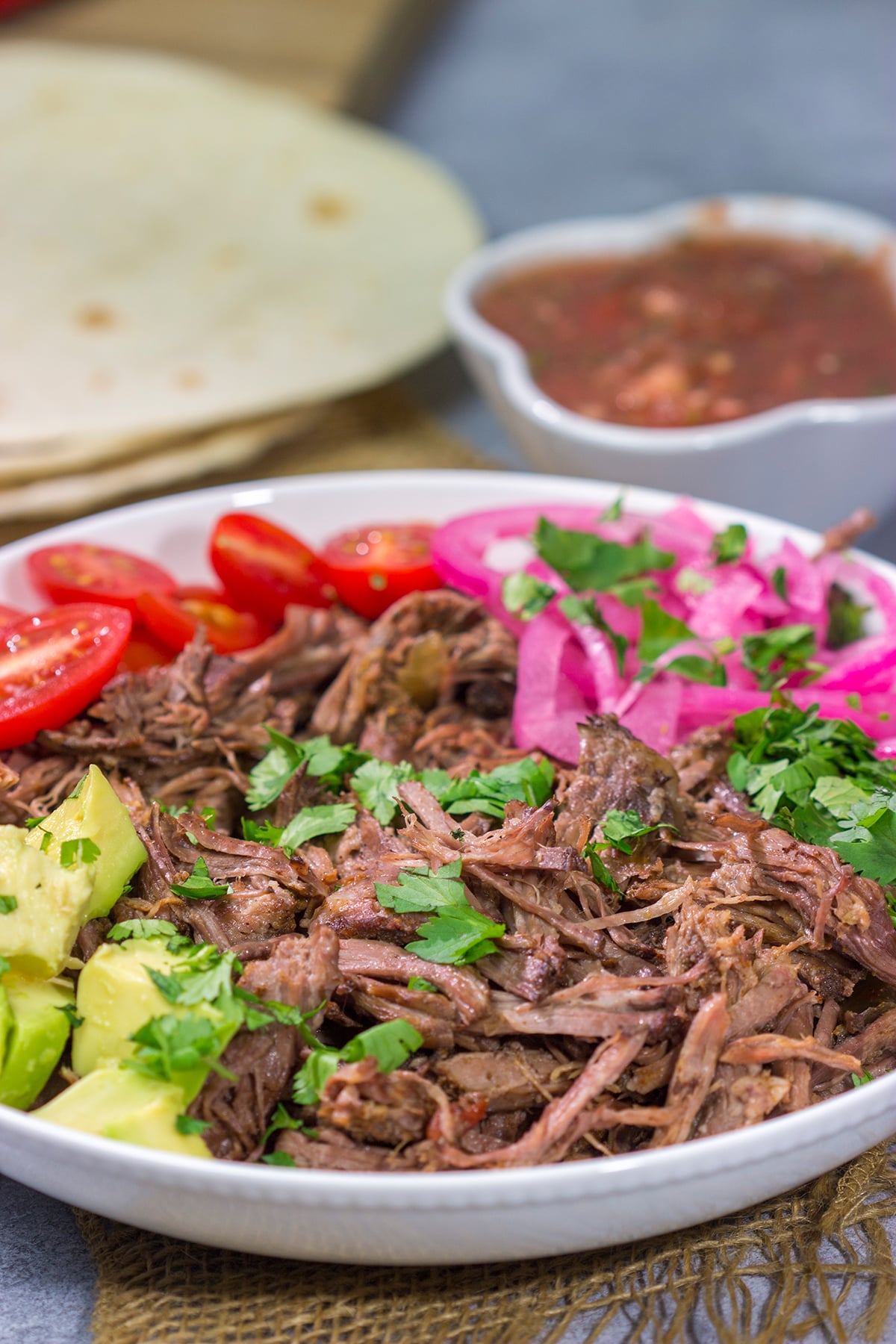 This Slow Cooker Mexican Shredded Beef recipe is tender, juicy and delicious! It's perfect for tacos, burritos or soups and stews. Make a batch tonight, and you'll have meals for the week!