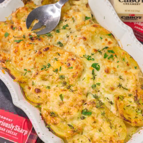 This Cheesy Scalloped Potatoes recipe features layers of potatoes, onions and shredded cheddar cheese. It's a fantastic side dish for dinner!
