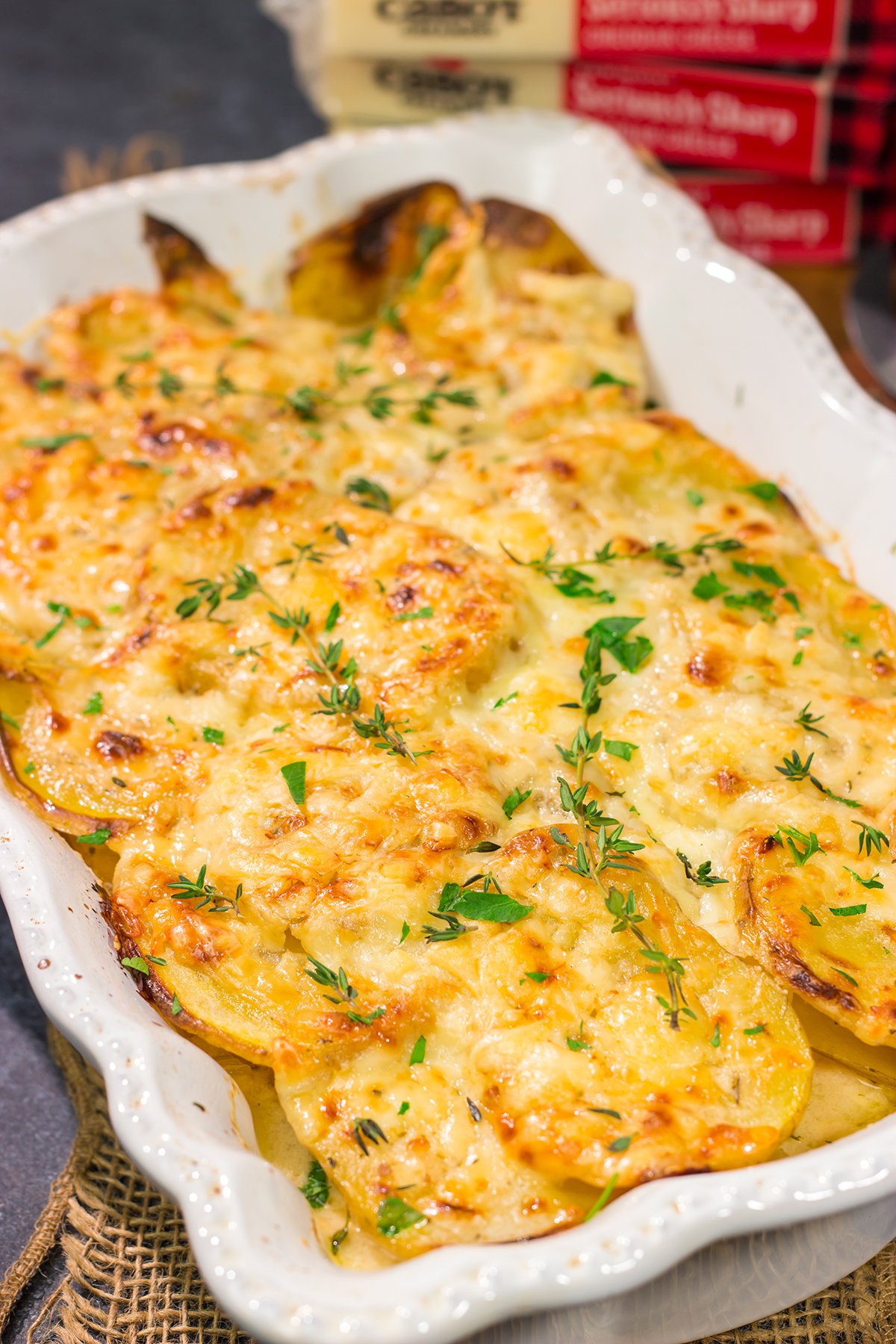 This Cheesy Scalloped Potatoes recipe features layers of potatoes, onions and shredded cheddar cheese. It's a fantastic side dish for dinner!
