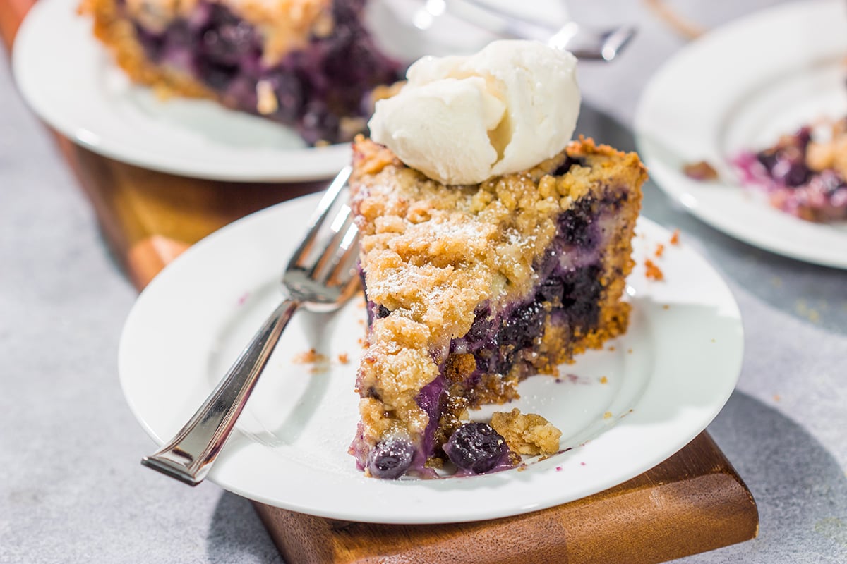 Featuring a sweet custard poured over juicy blueberries, this Blueberry Cream Pie is packed with summer flavor! Grab a slice and enjoy!