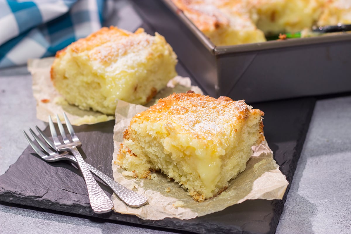 A classic St. Louis dessert, a Gooey Butter Cake features a buttery cake base topped with a vanilla cream cheese layer - it is absolutely addicting! Say hello to your new favorite dessert!