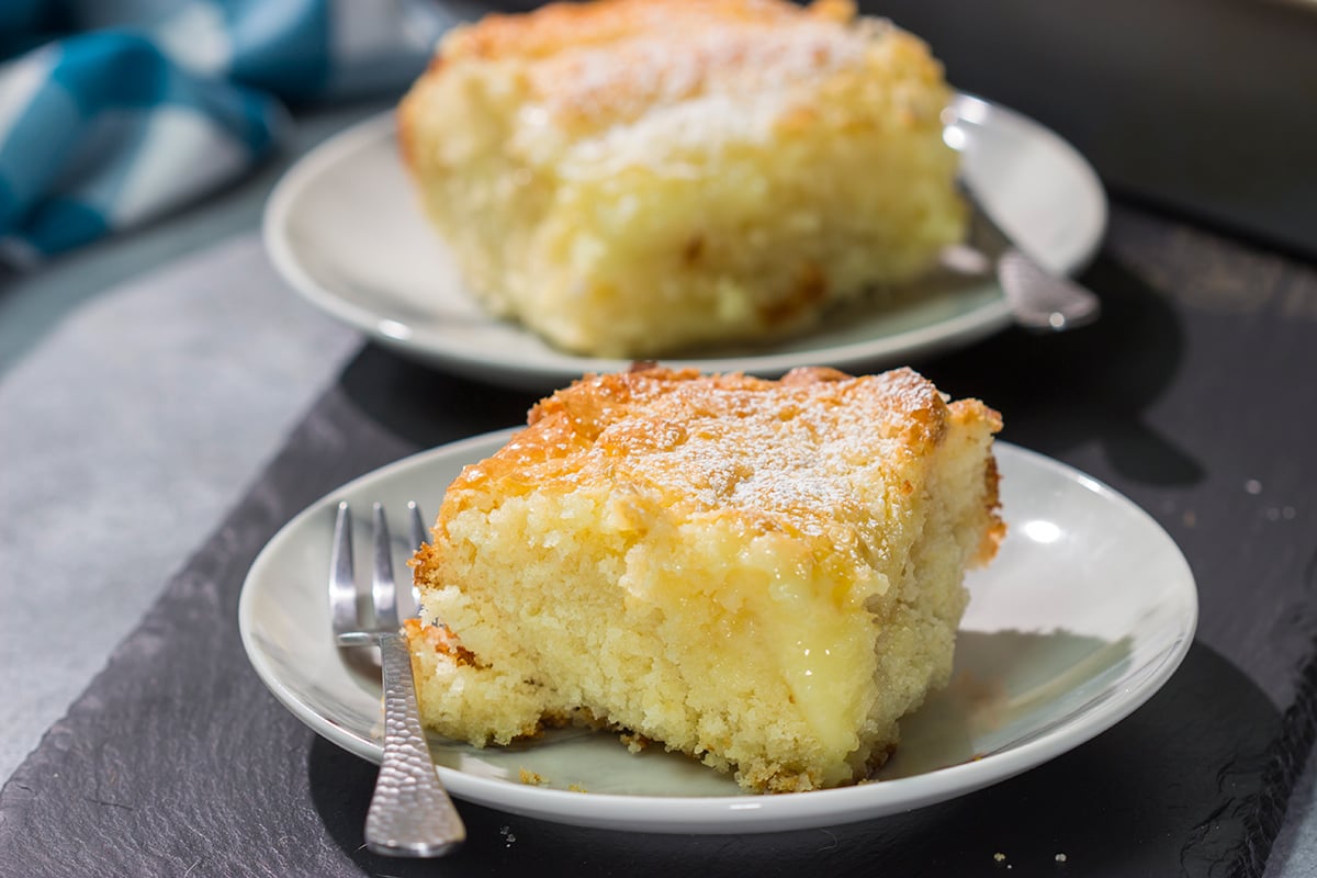 A classic St. Louis dessert, a Gooey Butter Cake features a buttery cake base topped with a vanilla cream cheese layer - it is absolutely addicting! Say hello to your new favorite dessert!