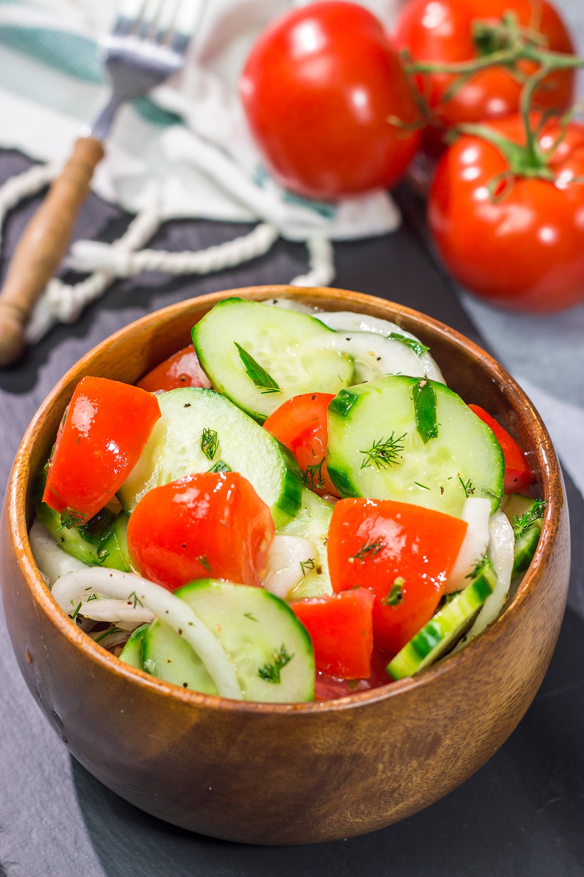 This easy Tomato, Cucumber and Onion Salad is a delicious summer recipe! This versatile side dish pairs well with almost anything.