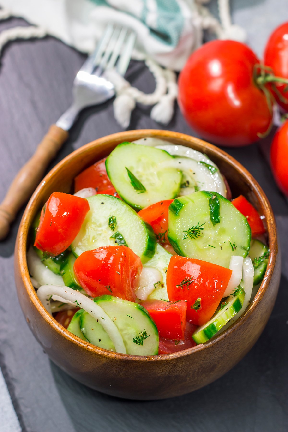 This easy Tomato, Cucumber and Onion Salad is a delicious summer recipe! This versatile side dish pairs well with almost anything.
