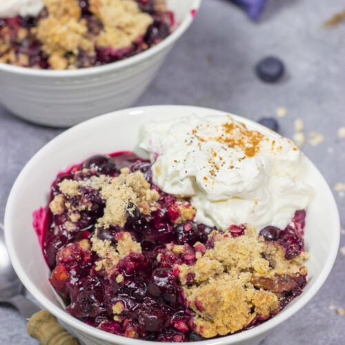 This classic Blueberry Crisp recipe features a juicy berry filling topped with a crispy oat streusel. It's the perfect dessert for warm summer evenings!