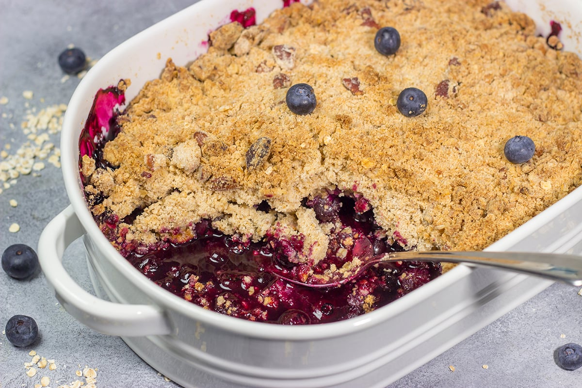 This classic Blueberry Crisp recipe features a juicy berry filling topped with a crispy oat streusel. It's the perfect dessert for warm summer evenings!