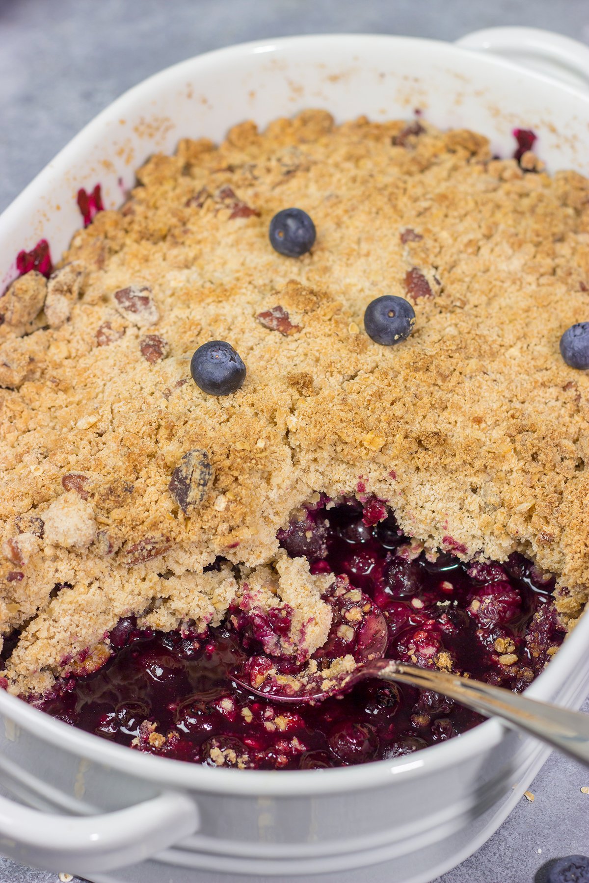 This classic Blueberry Crisp recipe features a juicy berry filling topped with a crispy oat streusel. It's the perfect dessert for warm summer evenings!