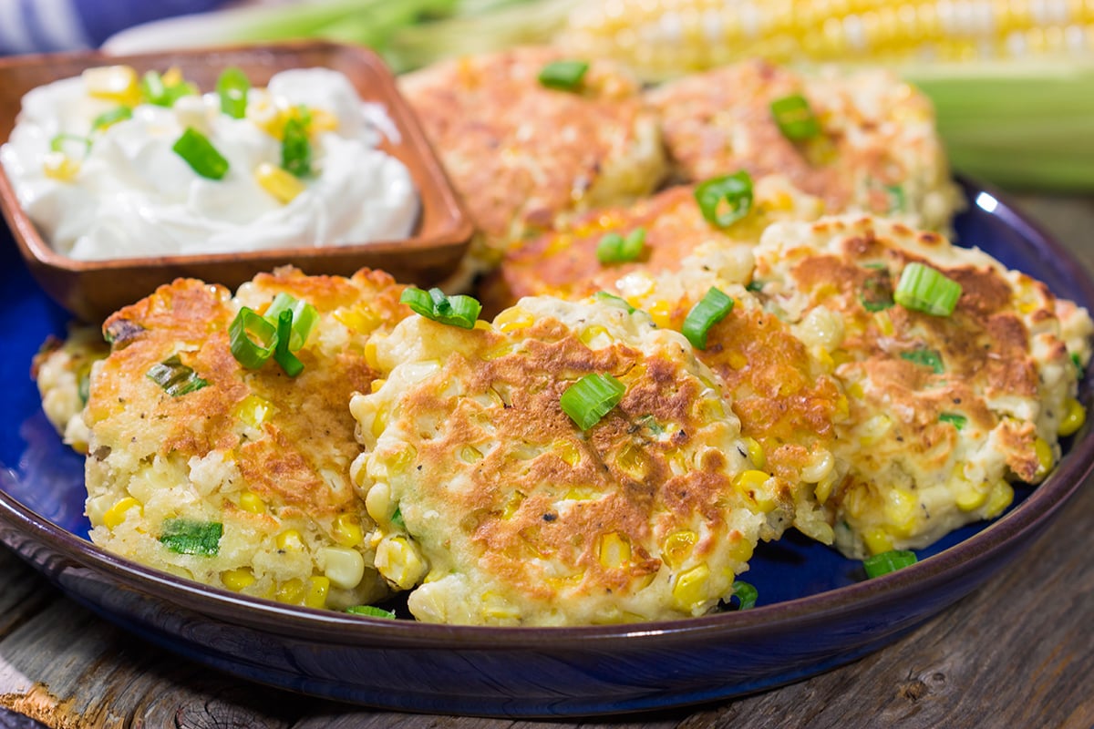These Corn Fritters feature fresh corn kernels mixed into a simple batter. Serve with a side of sour cream for a delicious summer side dish or appetizer!