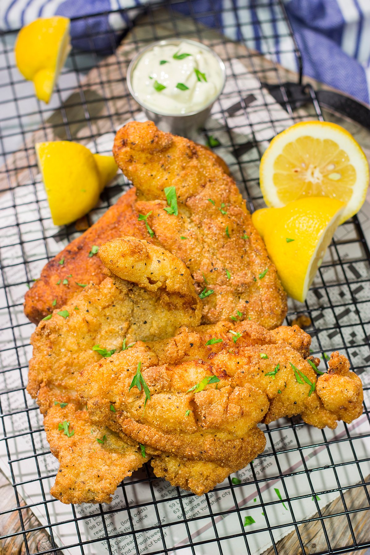 This Fried Catfish features a crispy cornmeal crust over tender catfish filets. Add in a squeeze of lemon and some homemade tartar sauce, and you've got a delicious fish fry recipe!