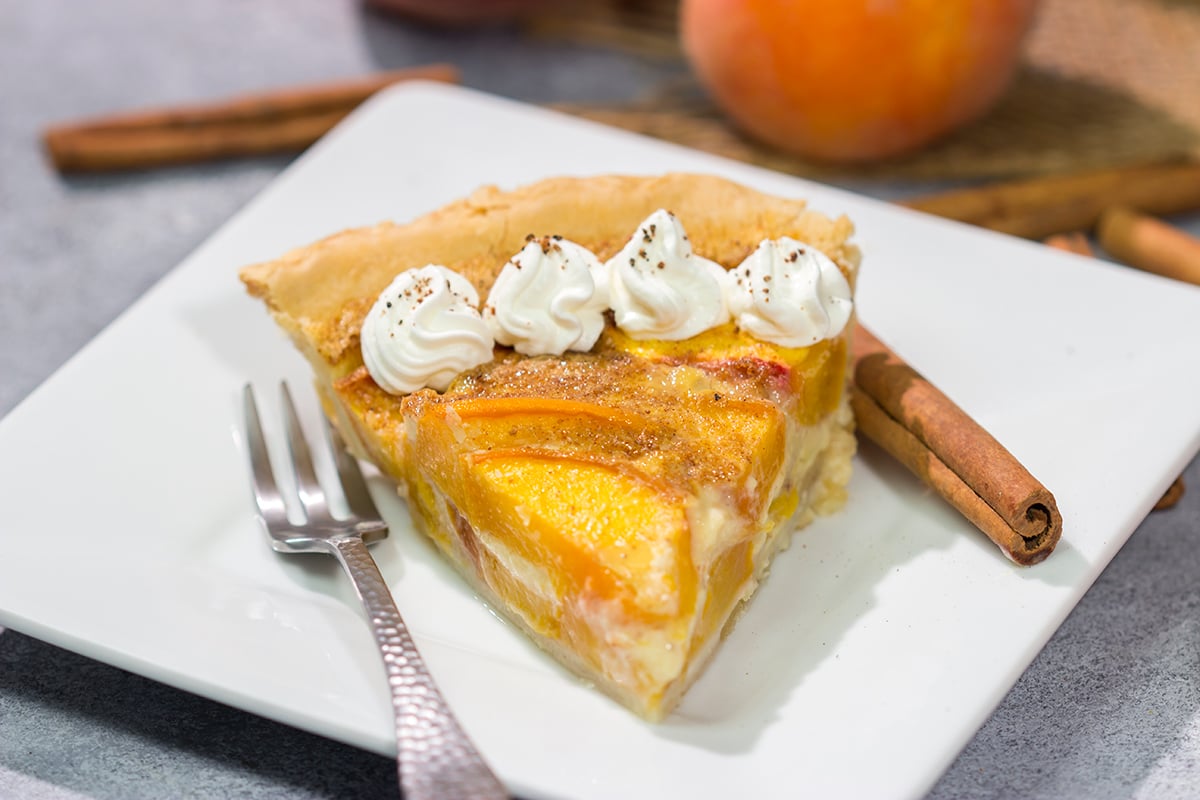 This Peaches and Cream Pie is a fun nod to the old-fashioned dessert of sliced peaches with fresh cream. The flavor of the fresh peaches makes this the perfect summer dessert recipe!