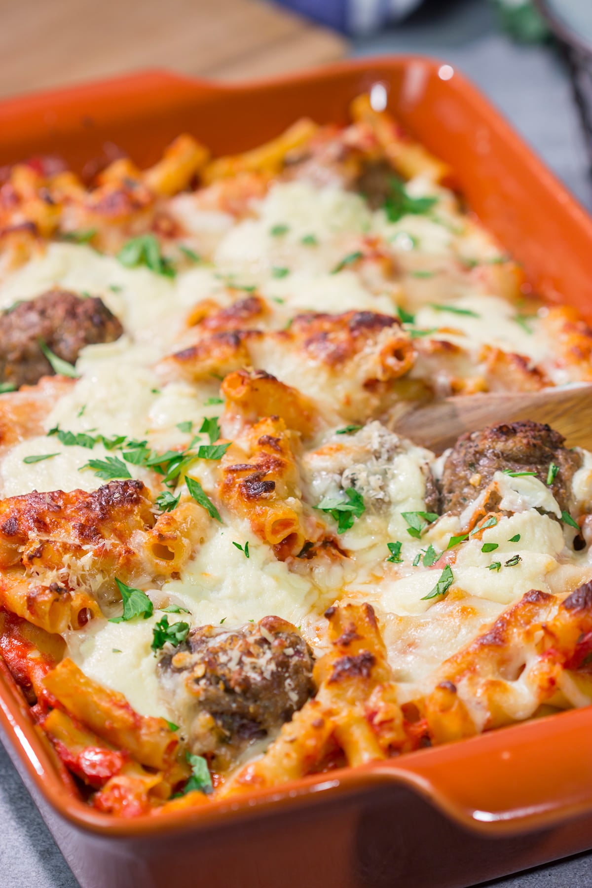 This Baked Ziti with Meatballs recipe is the ultimate comfort food. Pasta, gooey melted cheese and meatballs combine to create a delicious casserole!