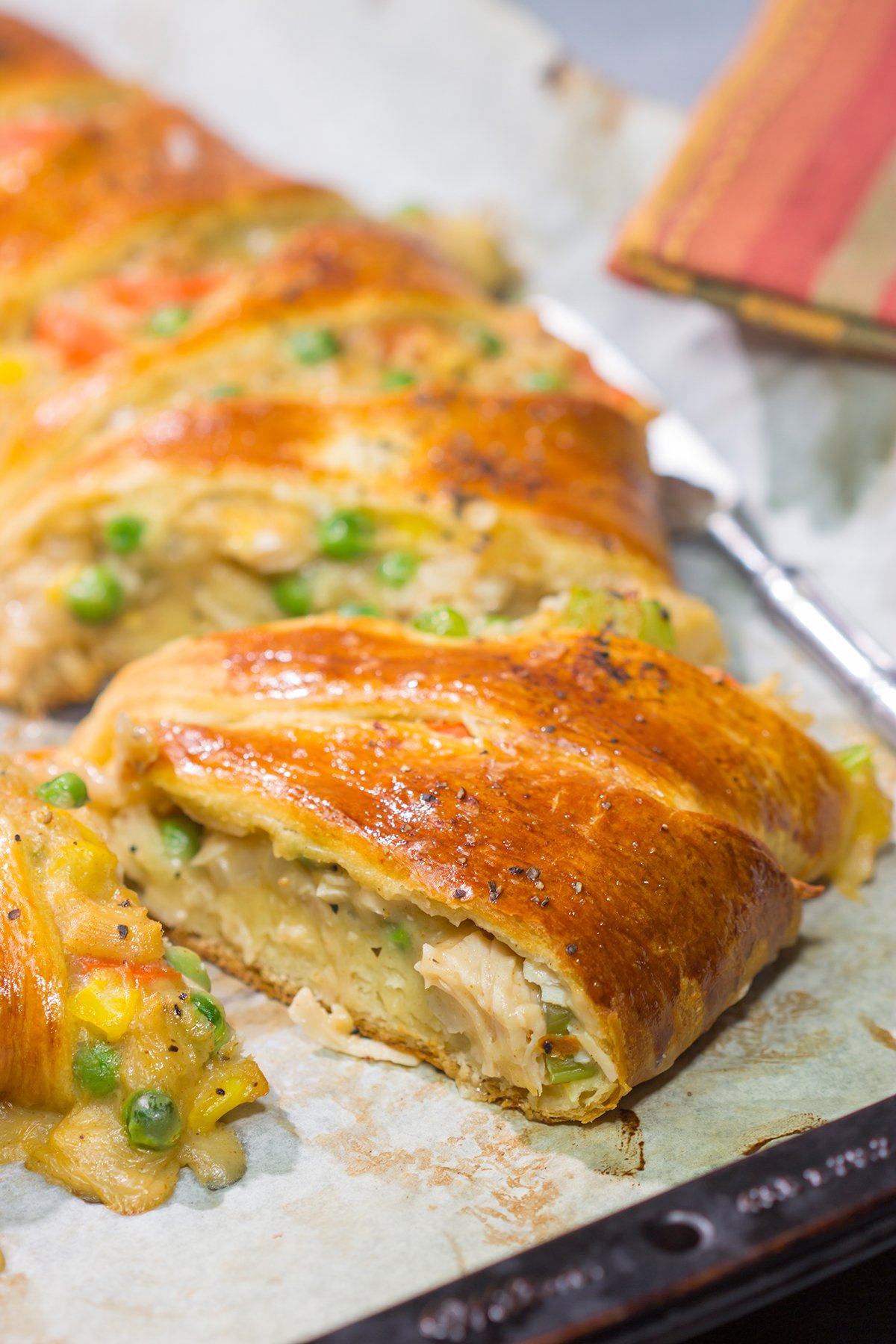 Put a unique spin on dinner with this Chicken Pot Pie Wreath! Homemade pot pie filling is wrapped in flaky crescent dough and shaped into a wreath for a fun take on a classic comfort food meal!