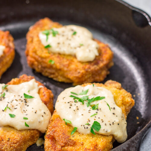 Fried Pork Chops are a classic Southern comfort food! These crispy, tender pork chops are served with an easy homemade gravy on top for maximum flavor.