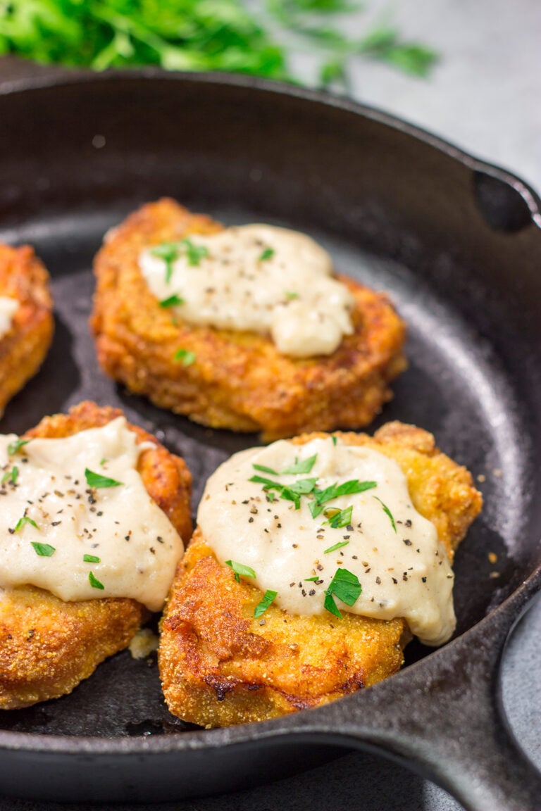 Fried Pork Chops are a classic Southern comfort food! These crispy, tender pork chops are served with an easy homemade gravy on top for maximum flavor.