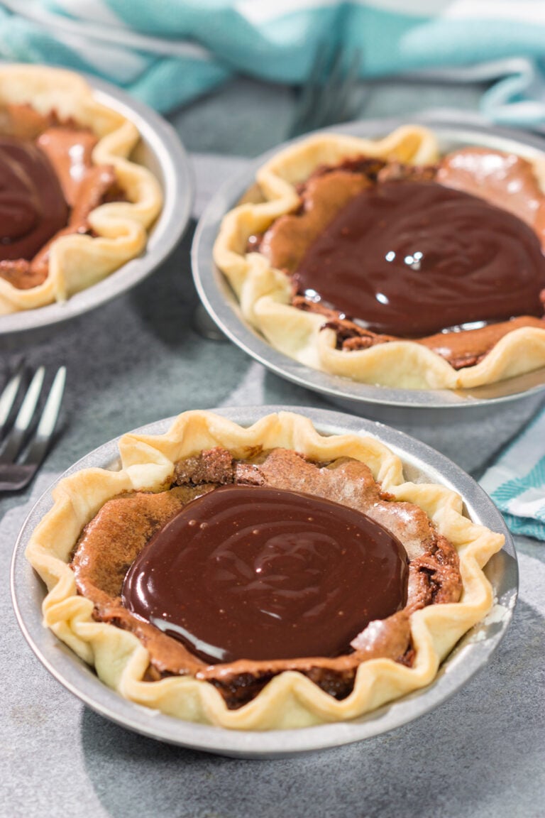These Mini Fudge Pies are perfect for all chocolate lovers! These pies feature a chocolate chess filling topped with decadent chocolate ganache. Yum!!