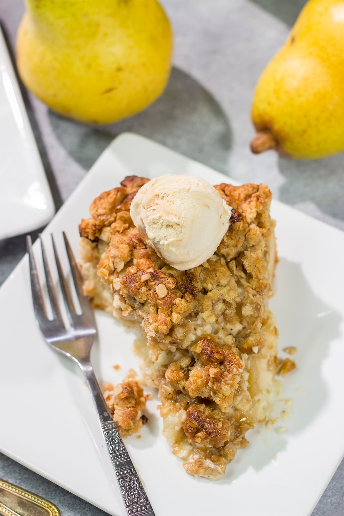 Sweet pears get tossed with a sour cream pie filling for a delicious and easy autumn dessert. This Pear Crumble Pie also gets topped with a brown sugar crumble - delicious!