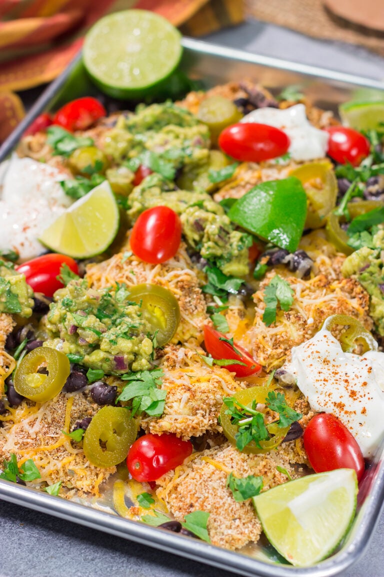 Skip the chips! These Toasted Ravioli Nachos feature all of your favorite nacho toppings on top of toasted ravioli. Go ahead and make an extra batch...you'll need it!