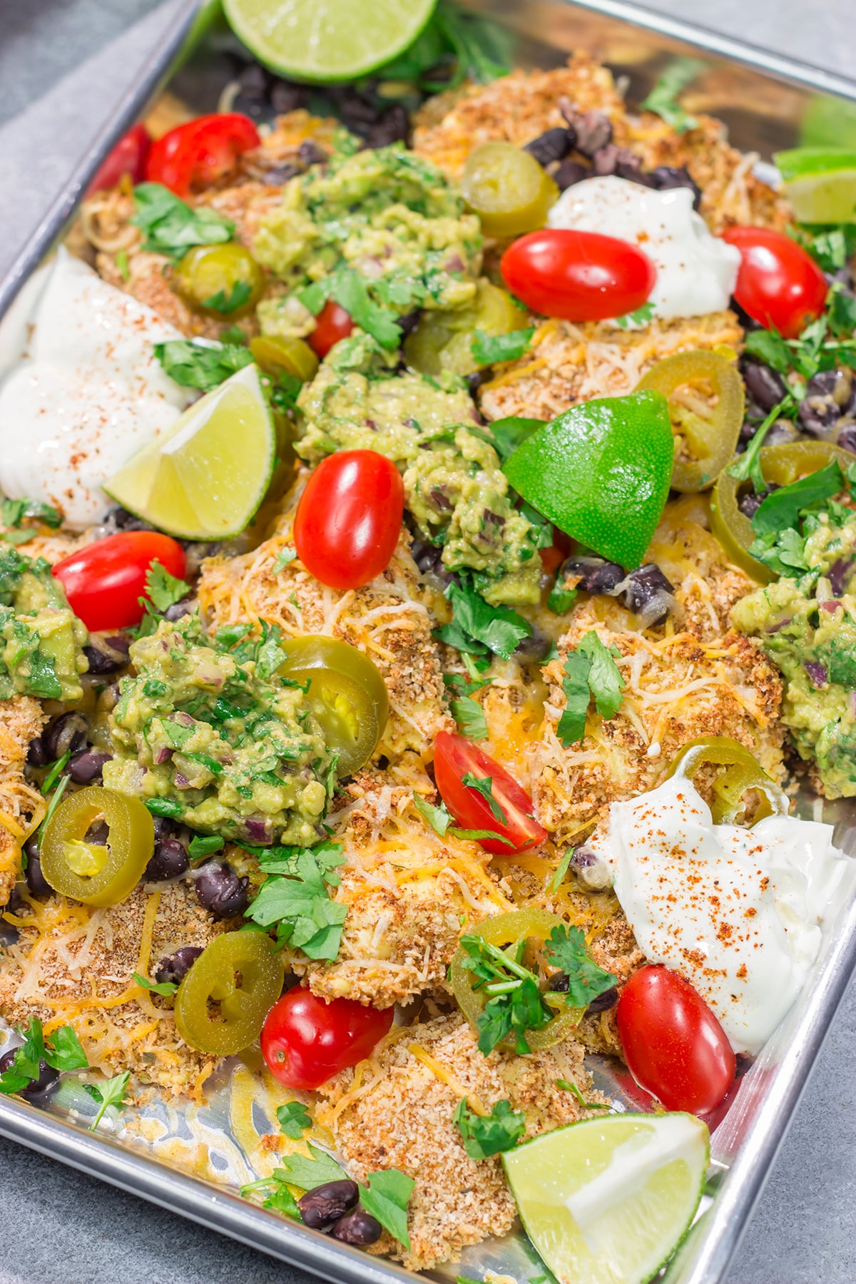 Skip the chips! These Toasted Ravioli Nachos feature all of your favorite nacho toppings on top of toasted ravioli. Go ahead and make an extra batch...you'll need it!