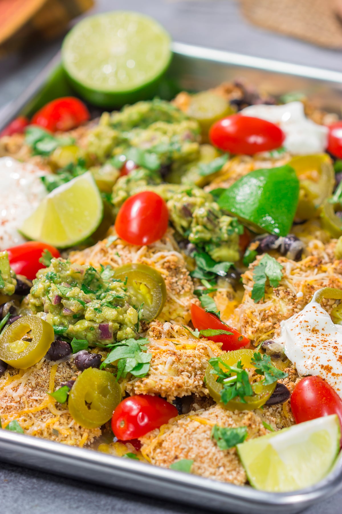 Skip the chips! These Toasted Ravioli Nachos feature all of your favorite nacho toppings on top of toasted ravioli. Go ahead and make an extra batch...you'll need it!
