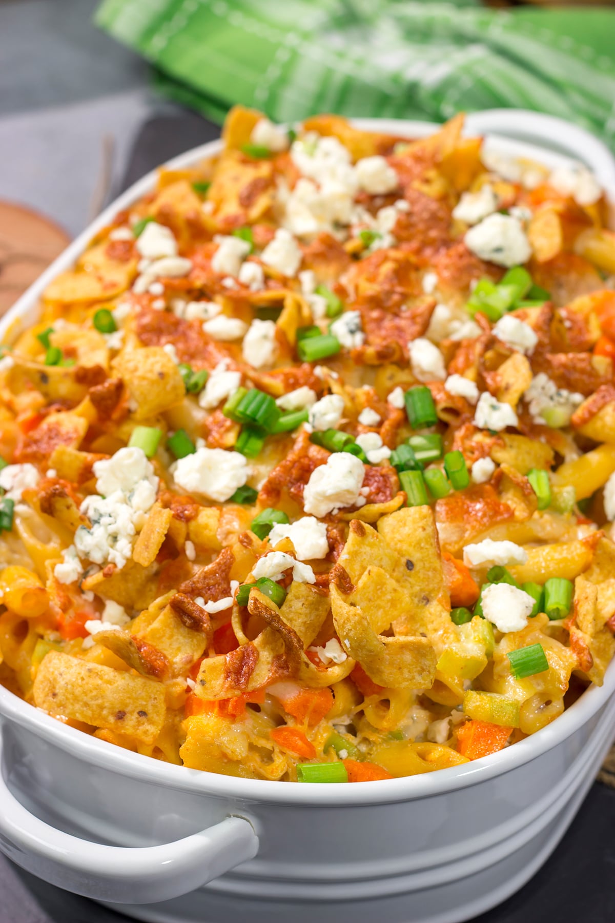 This Buffalo Chicken Casserole features the spicy flavor of buffalo wings combined with the cozy comfort of a pasta bake. This hearty meal is perfect for gamedays or dinners at home!
