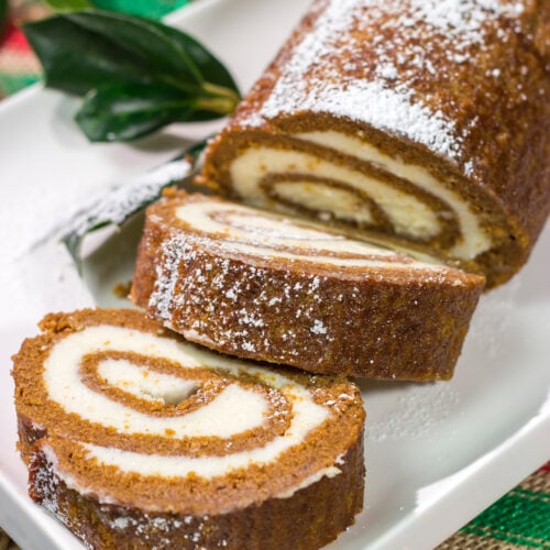 Get into the holiday spirit with this Gingerbread Cake Roll! This festive dessert features a thin gingerbread cake filled with a light and fluffy cream cheese frosting - it's perfect for holiday parties!