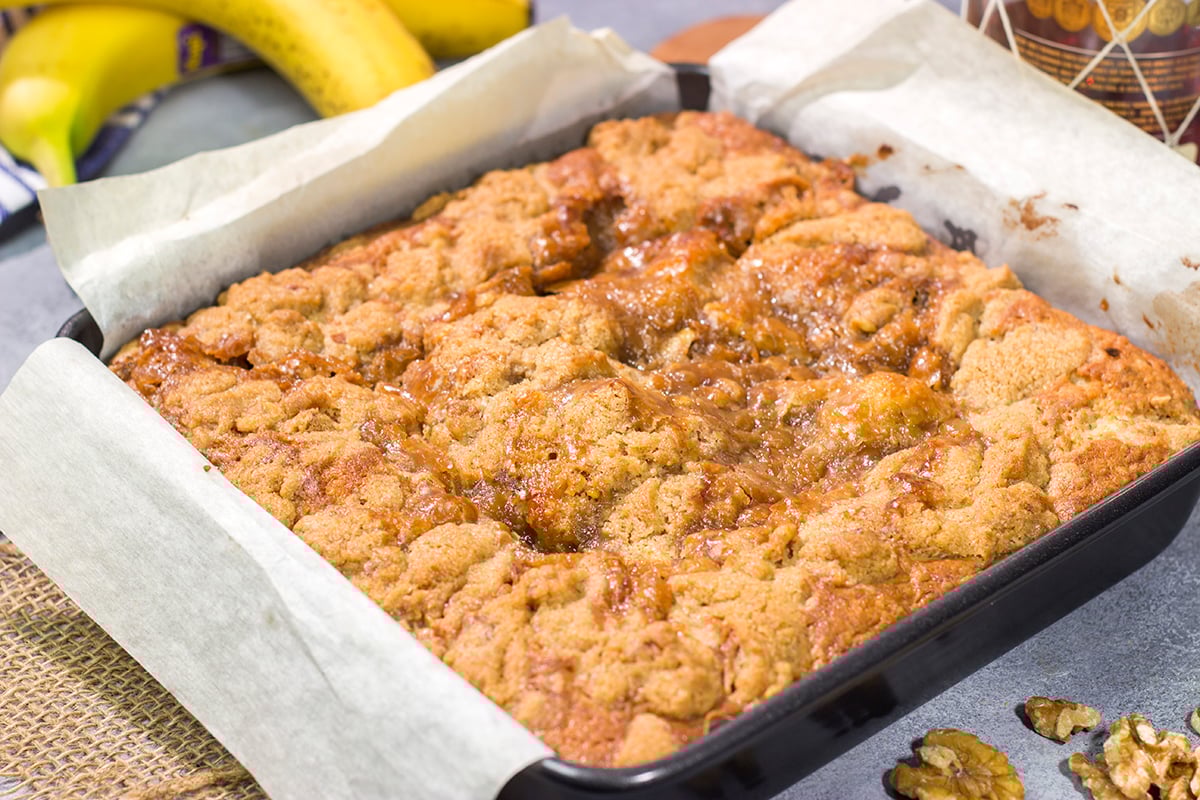 Featuring the flavors of the classic New Orleans dessert, this Bananas Foster Cake is truly fantastic! The tender cake is topped with a brown sugar streusel and rum sauce. Grab a fork!