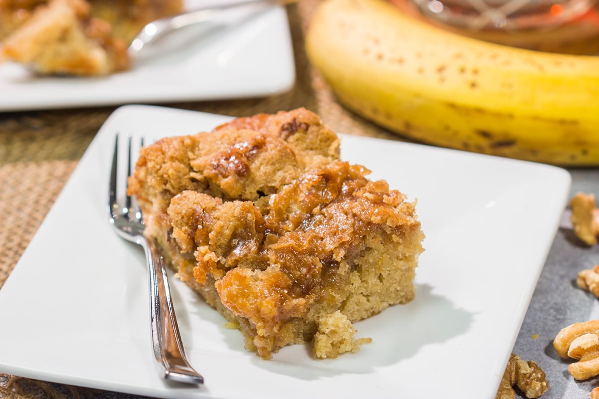 Featuring the flavors of the classic New Orleans dessert, this Bananas Foster Cake is truly fantastic! The tender cake is topped with a brown sugar streusel and rum sauce. Grab a fork!