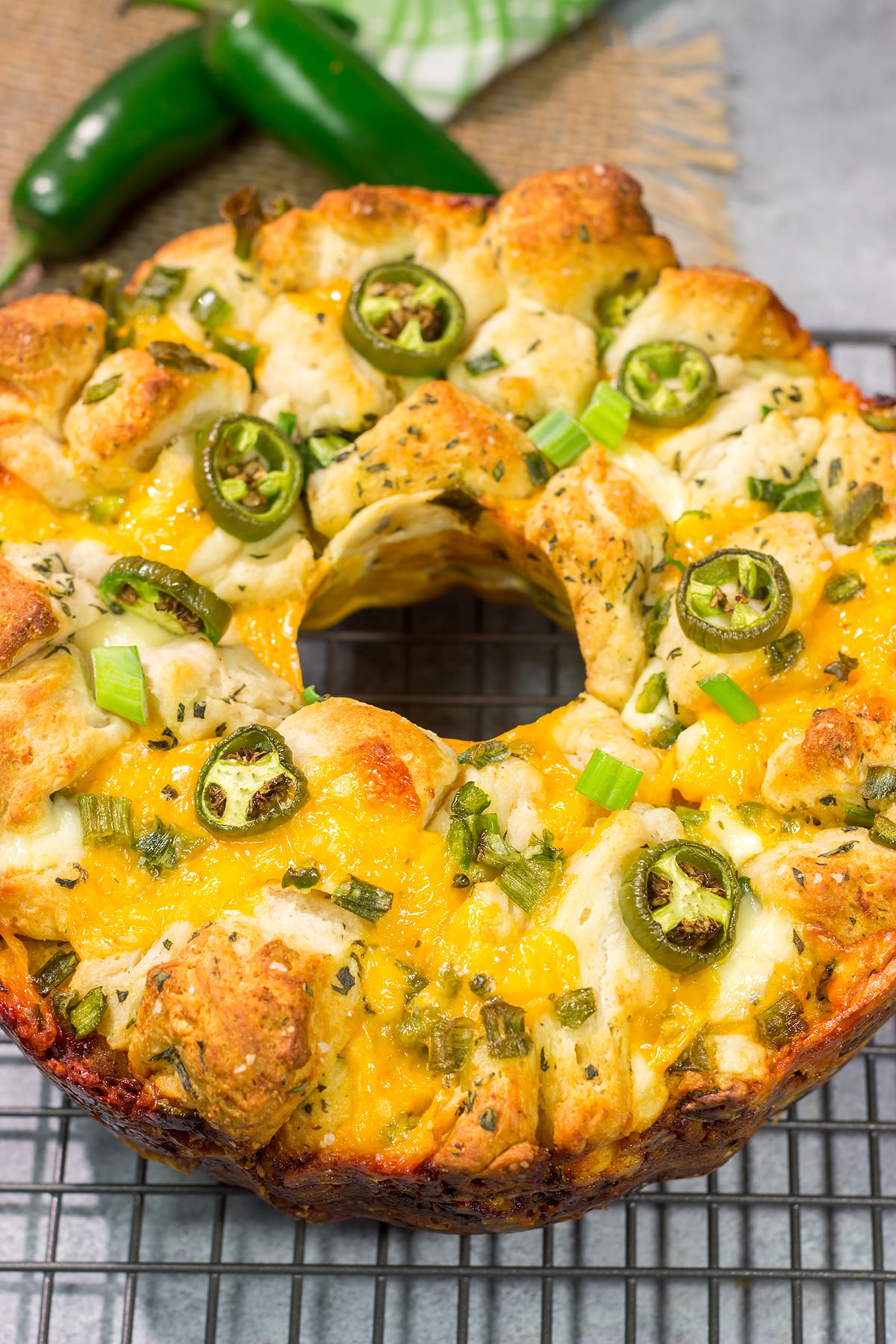 A warm loaf of this Jalapeno Cheddar Monkey Bread will be an instant favorite! This bread combines gooey melted cheese with fresh herbs and diced jalapenos - it's the ultimate comfort food.