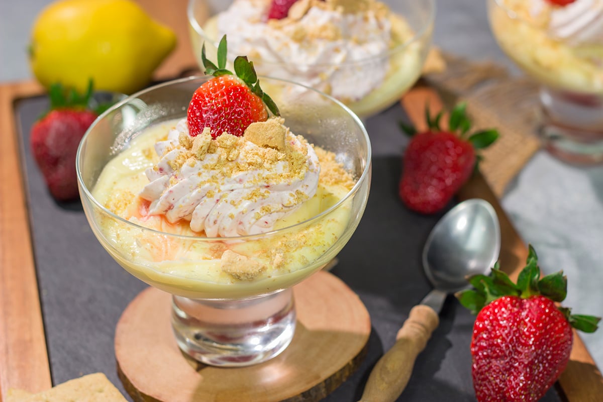This Lemon Strawberry Pudding dessert features fresh, juicy strawberries layered with a mouthwatering lemon pudding. Oh, and don't forget the strawberry whipped cream on top!