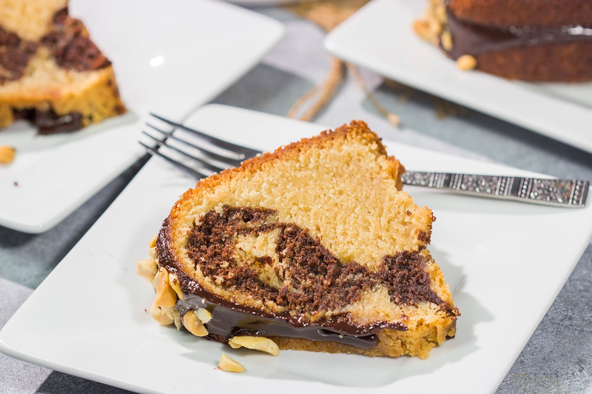 Featuring swirls of chocolate and peanut butter cake, this Chocolate Peanut Butter Pound Cake makes for a fun (and delicious) dessert recipe!