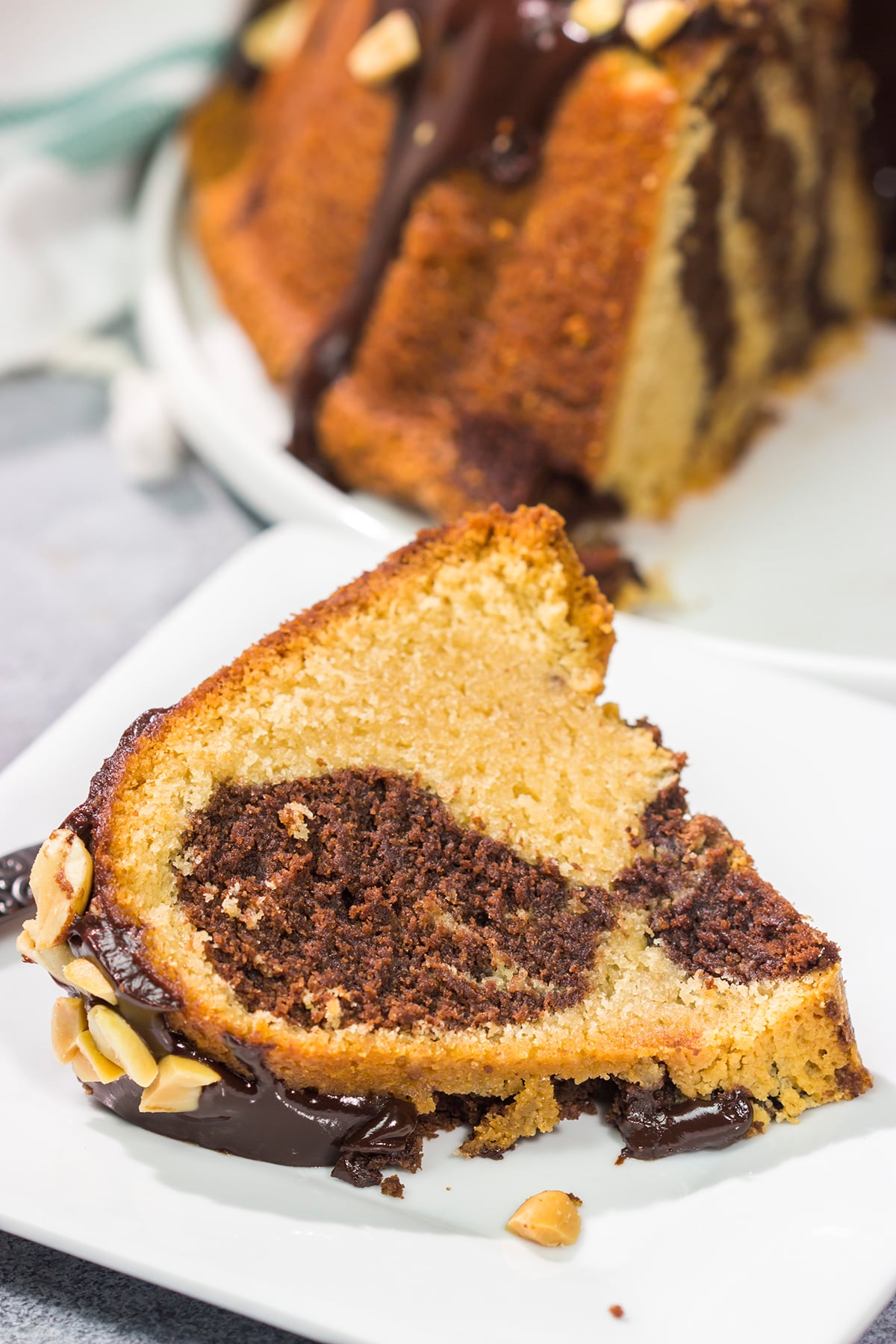 Featuring swirls of chocolate and peanut butter cake, this Chocolate Peanut Butter Pound Cake makes for a fun (and delicious) dessert recipe!