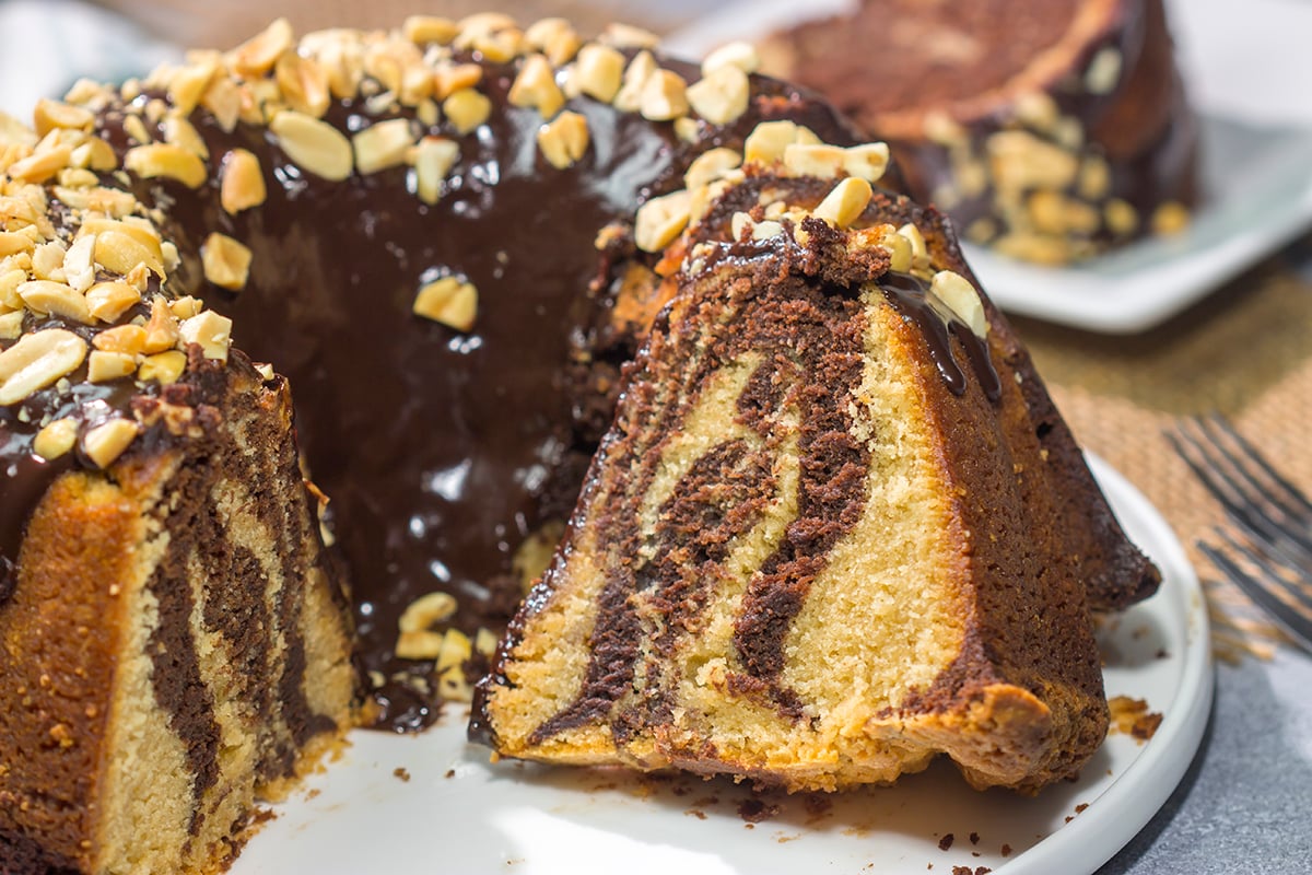 Featuring swirls of chocolate and peanut butter cake, this Chocolate Peanut Butter Pound Cake makes for a fun (and delicious) dessert recipe!