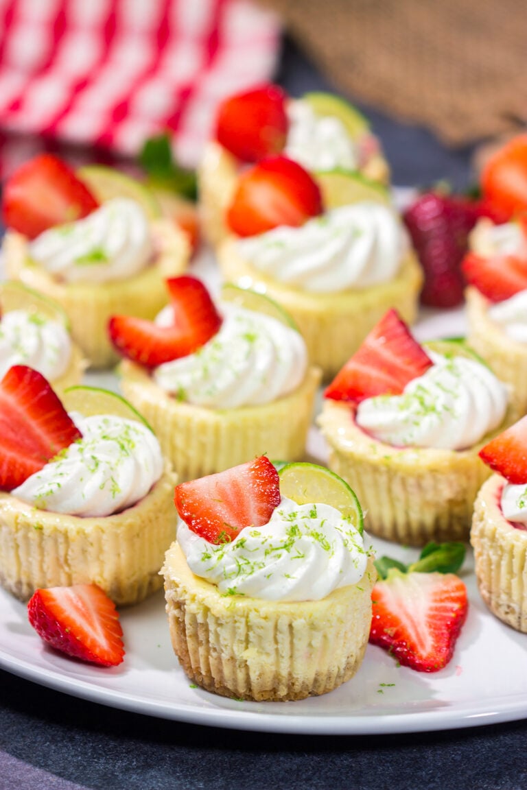 Featuring a splash of tequila and a swirl of fresh strawberry puree, these Mini Strawberry Margarita Cheesecakes are the perfect dessert for summer celebrations!
