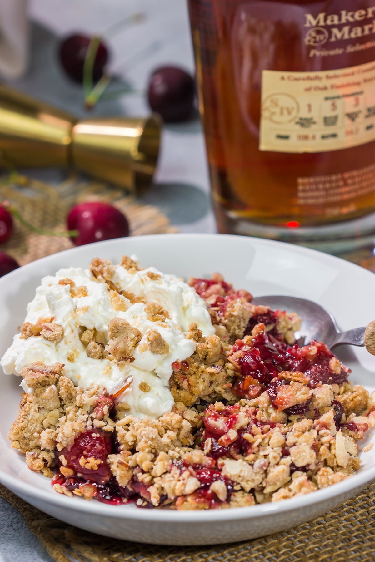 This Homemade Cherry Crisp is a simple dessert that the whole family will love. The homemade cherry filling gets topped with a crispy oat streusel...and a dollop of bourbon whipped cream!
