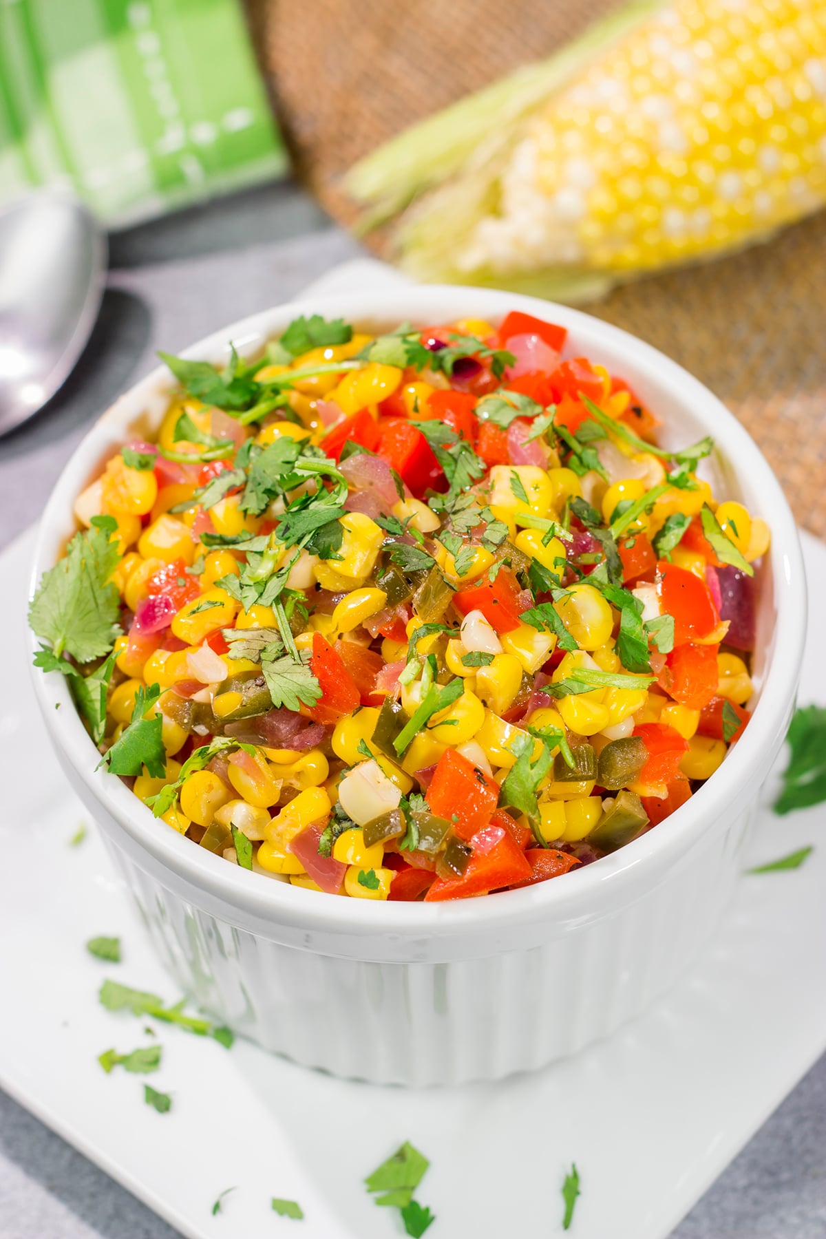 Featuring sweet corn and bell peppers combined with spicy jalapenos and tossed in lime butter, this Mexicali Corn recipe is a tasty side dish for summer meals!