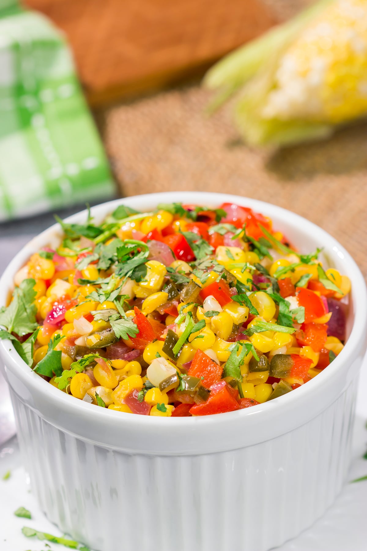 Featuring sweet corn and bell peppers combined with spicy jalapenos and tossed in lime butter, this Mexicali Corn recipe is a tasty side dish for summer meals!