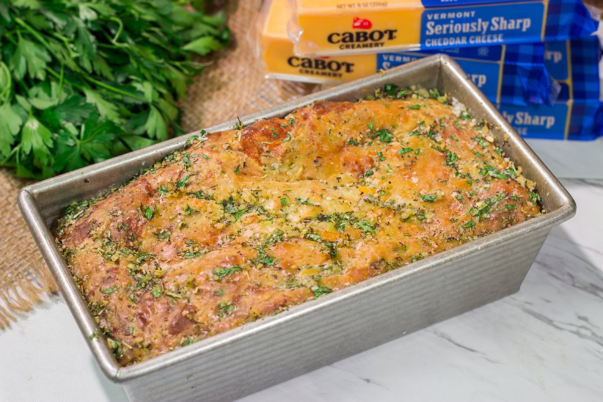 This Cheesy Zucchini Bread is packed with summer flavor! Toast up a slice of this savory quick bread and serve it next to salad or soup for an easy meal.