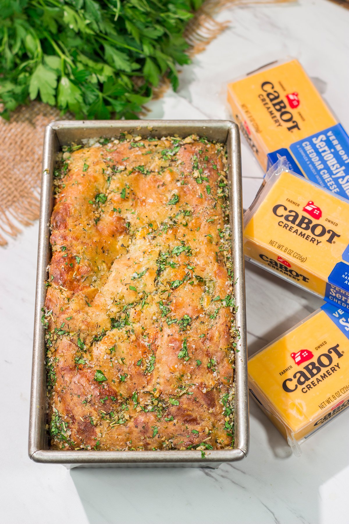 This Cheesy Zucchini Bread is packed with summer flavor! Toast up a slice of this savory quick bread and serve it next to salad or soup for an easy meal.
